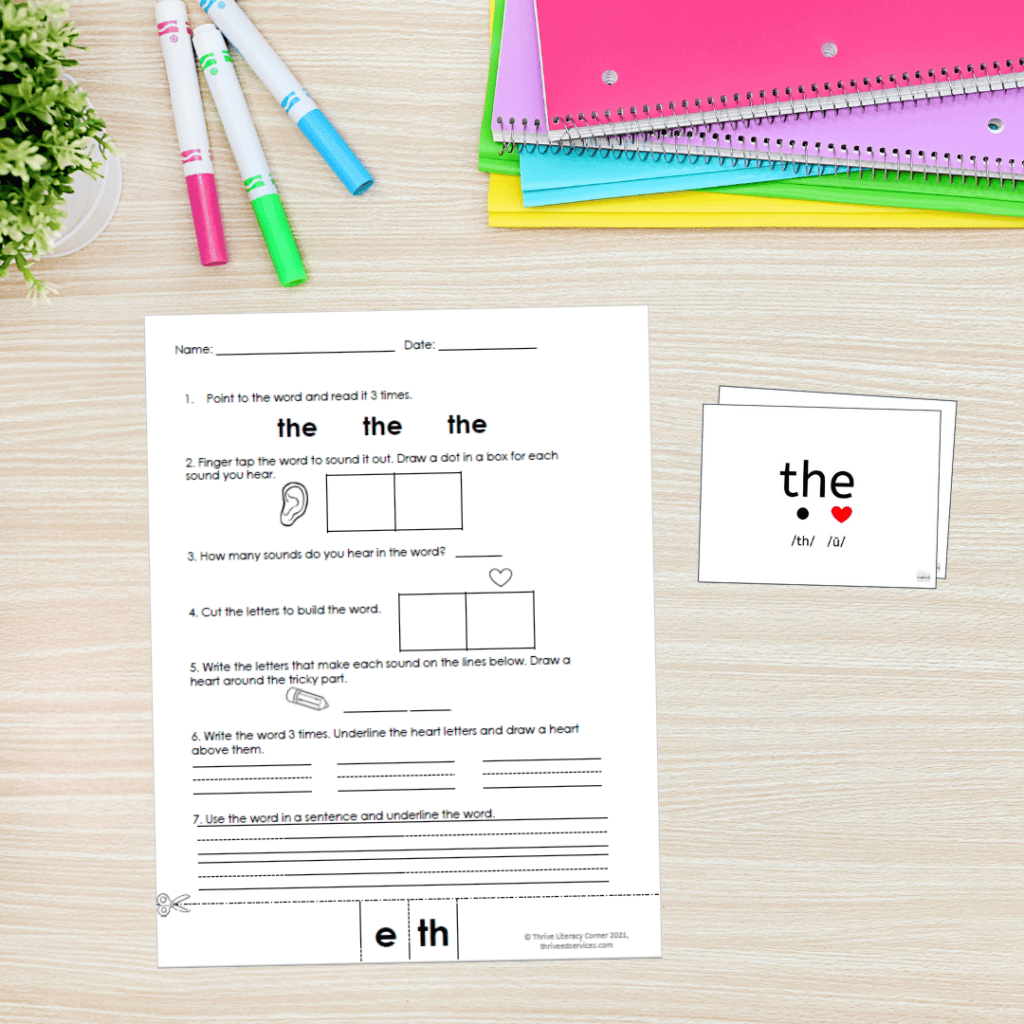 high frequency word 'the' practice page on a desk